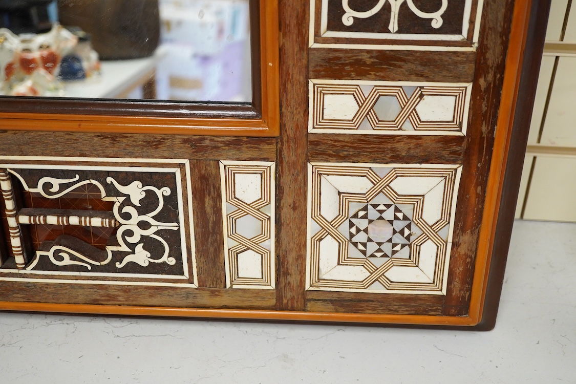 A Moroccan bone and abalone inlaid wall mirror